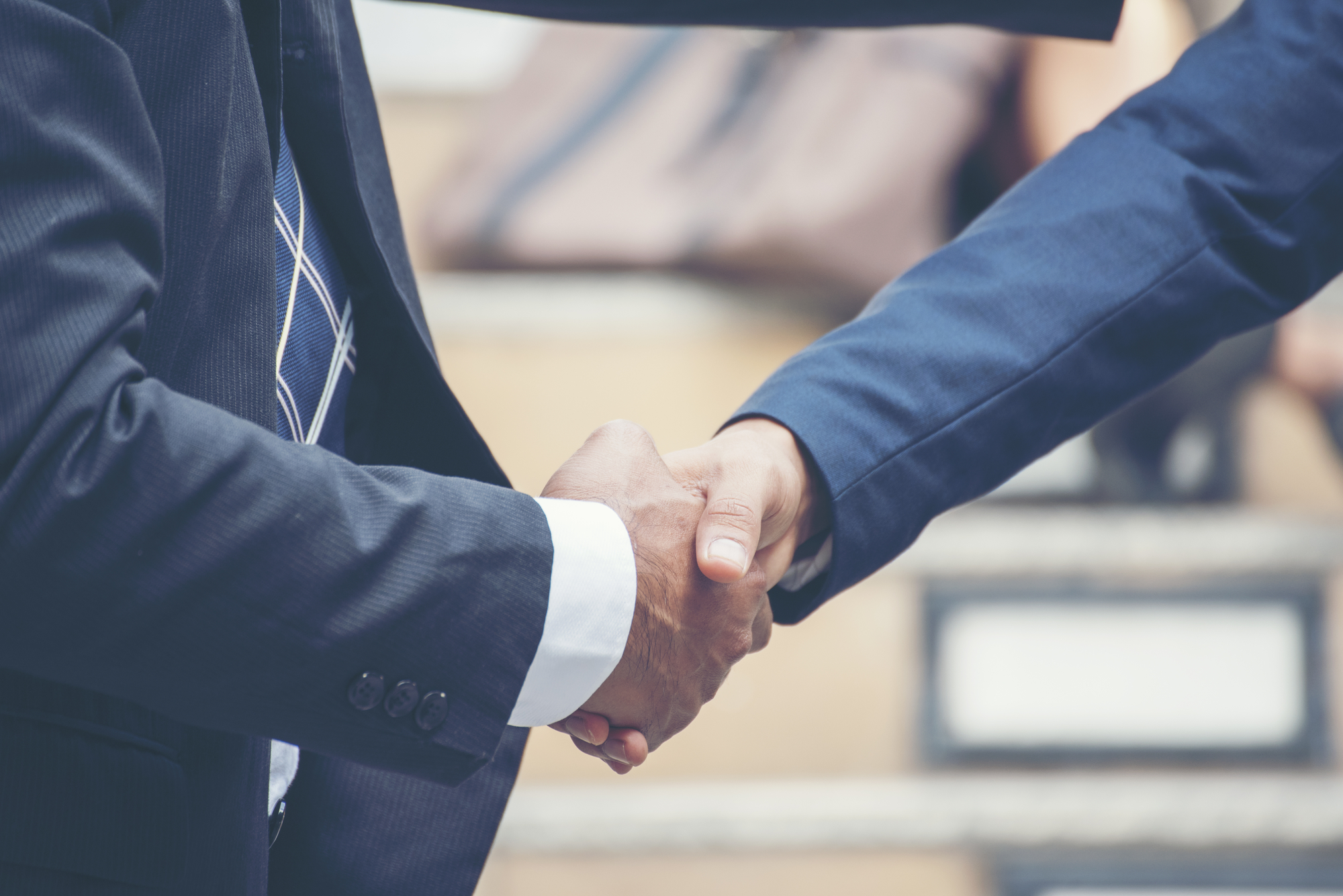 CLose up of business persons shaking hands